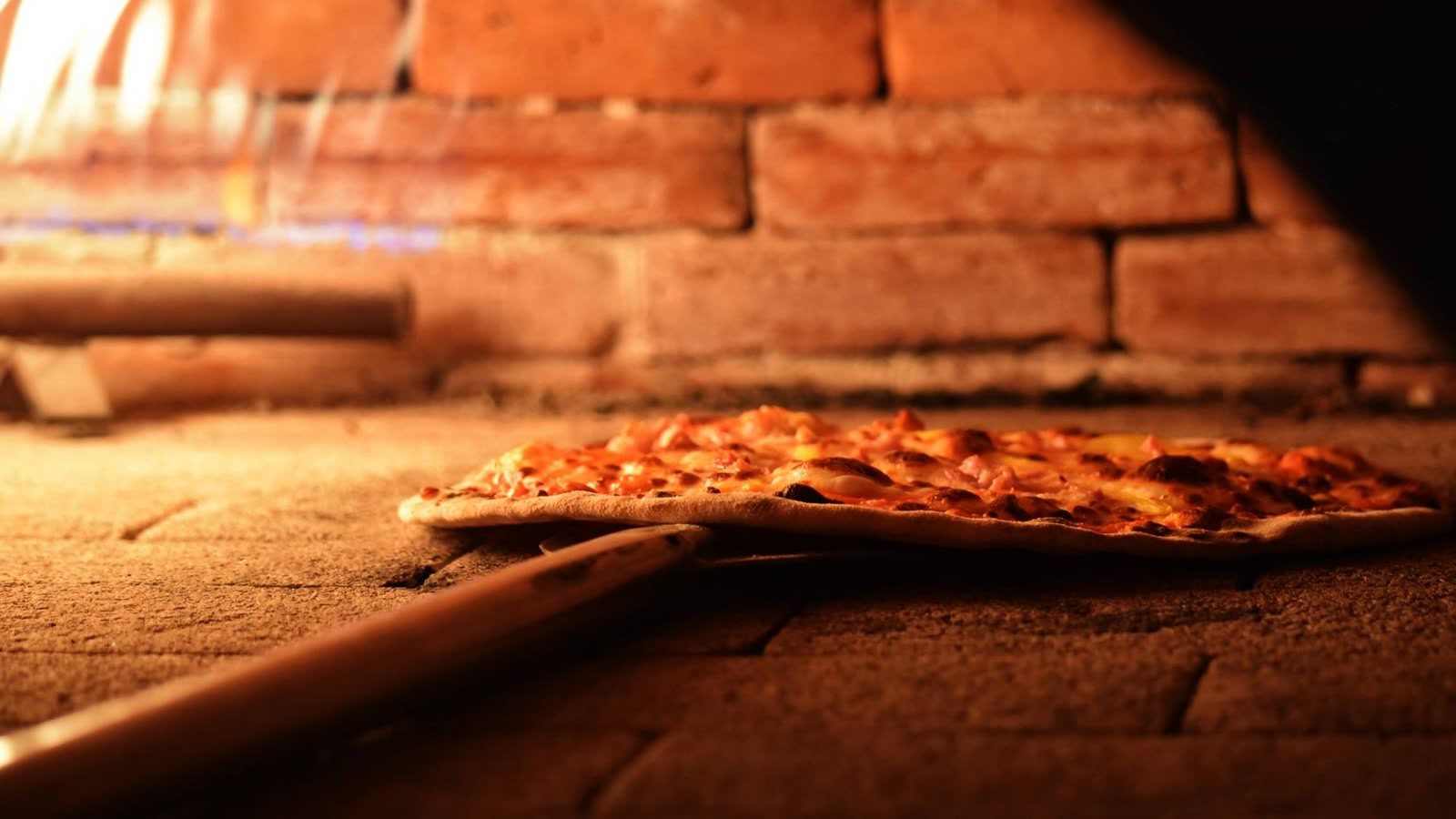 Pizza saliendo del horno de piedra de Mr. Lasaña, Cancún